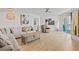 Bright living room with hardwood floors, sectional sofa, and large windows at 231 Riverside Dr # 1904, Daytona Beach, FL 32117