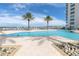 Community pool with plenty of lounge chairs and a view of the water at 231 Riverside Dr # 1904, Daytona Beach, FL 32117