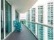 Private balcony with teal chairs and building views at 231 Riverside Dr # 1904, Daytona Beach, FL 32117