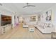 Living room with hardwood floors and large TV at 231 Riverside Dr # 1904, Daytona Beach, FL 32117
