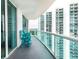 Private balcony with teal chairs and building views at 231 Riverside Dr # 1904, Daytona Beach, FL 32117