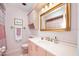 Pink bathroom with vanity, toilet, and shower at 235 Coquina Ave, Ormond Beach, FL 32174