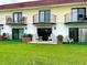Condo building with balconies, patio furniture, and green space at 64 Ocean Palm S Dr # 64, Flagler Beach, FL 32136