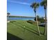 Scenic waterfront view with lush green lawn and palm trees at 64 Ocean Palm S Dr # 64, Flagler Beach, FL 32136