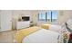 Bedroom with two twin beds, wicker dresser, and window at 1513 Ocean Shore Blvd # 6C, Ormond Beach, FL 32176