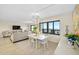 Dining area with white table, chairs, and ocean view at 1513 Ocean Shore Blvd # 6C, Ormond Beach, FL 32176