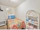 Cozy bedroom with full-size bed and shelving at 1513 Ocean Shore Blvd # 6C, Ormond Beach, FL 32176