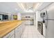 Modern kitchen with wood countertops and stainless steel appliances at 1513 Ocean Shore Blvd # 6C, Ormond Beach, FL 32176