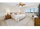 Spacious main bedroom with king bed, ocean view, and ceiling fan at 1513 Ocean Shore Blvd # 6C, Ormond Beach, FL 32176