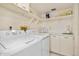 Laundry room with washer, dryer, and storage shelves at 1513 Ocean Shore Blvd # 6C, Ormond Beach, FL 32176