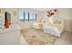 Bedroom with two twin beds, a rug, and window at 1513 Ocean Shore Blvd # 6C, Ormond Beach, FL 32176