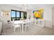 Elegant dining room featuring a white table and modern art at 1513 Ocean Shore Blvd # 6C, Ormond Beach, FL 32176