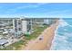 Aerial view showing beachfront building and ocean at 1513 Ocean Shore Blvd # 6C, Ormond Beach, FL 32176