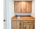 Small wet bar with wood cabinets and a sink at 2600 Ocean Shore Blvd # 3060, Ormond Beach, FL 32176