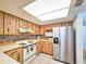 Bright kitchen features wood cabinets, tile backsplash, and stainless steel appliances at 2600 Ocean Shore Blvd # 3060, Ormond Beach, FL 32176