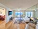 Ocean-view living room with hardwood floors, comfy seating, and large TV at 2600 Ocean Shore Blvd # 3060, Ormond Beach, FL 32176