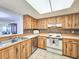 Kitchen boasts wood cabinets, tiled floors, and full-size appliances at 2600 Ocean Shore Blvd # 3060, Ormond Beach, FL 32176
