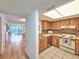 Kitchen with wood cabinets, tiled floors, and stainless steel appliances at 2600 Ocean Shore Blvd # 3060, Ormond Beach, FL 32176