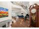 Grand entryway with hardwood floors, sweeping staircase, and views into the living area at 70 Riverside Dr, Ormond Beach, FL 32176