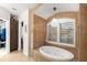 Spa-like bathroom with soaking tub and large window at 70 Riverside Dr, Ormond Beach, FL 32176