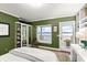 Serene bedroom with water views, built-in shelving, and a walkout balcony at 70 Riverside Dr, Ormond Beach, FL 32176