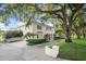 Side view of the home showcasing landscaping and driveway at 70 Riverside Dr, Ormond Beach, FL 32176