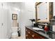 Elegant bathroom with dark wood vanity and a large ornate mirror at 70 Riverside Dr, Ormond Beach, FL 32176