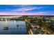 Night aerial view showcasing waterfront home, bridge and city lights at 70 Riverside Dr, Ormond Beach, FL 32176