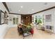 Relaxing living room with large windows, comfortable seating, and built-in shelving at 70 Riverside Dr, Ormond Beach, FL 32176