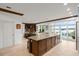 Kitchen with large island and water views from the adjacent living room at 70 Riverside Dr, Ormond Beach, FL 32176