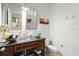 Bathroom with dark wood vanity, a large mirror, and a white tile shower at 70 Riverside Dr, Ormond Beach, FL 32176
