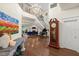 Bright foyer with hardwood floors, grand staircase, and large artwork at 70 Riverside Dr, Ormond Beach, FL 32176