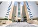 Ocean Eight building exterior, featuring entrance and landscaping at 2937 S Atlantic Ave # 1504, Daytona Beach, FL 32118