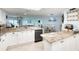 Open kitchen with granite counters, white cabinets, and ocean view at 2937 S Atlantic Ave # 1504, Daytona Beach, FL 32118