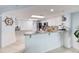 Open kitchen with granite countertops and white cabinets at 2937 S Atlantic Ave # 1504, Daytona Beach, FL 32118