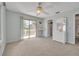 Spacious bedroom with sliding glass door to balcony and ceiling fan at 830 Eel Ave, New Smyrna Beach, FL 32169