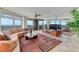 Spacious living room with curved sofa, large windows, and ocean views at 2545 S Atlantic Ave # 1701, Daytona Beach Shores, FL 32118