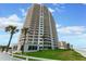 Oceanfront high-rise building with balconies and lush landscaping at 2545 S Atlantic Ave # 1701, Daytona Beach Shores, FL 32118