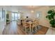Dining area with table and chairs, hardwood floors, and ocean views at 4525 S Atlantic Ave # 1502, Port Orange, FL 32127