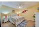 Bedroom with a queen bed, coastal decor, and ceiling fan at 4525 S Atlantic Ave # 1502, Port Orange, FL 32127