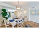 Bright dining area features a table for six, hardwood floors, and kitchen views at 4525 S Atlantic Ave # 1502, Port Orange, FL 32127