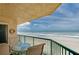 Oceanfront balcony with table and chairs at 4525 S Atlantic Ave # 1502, Port Orange, FL 32127