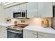 Stainless steel appliances and white cabinetry at 4525 S Atlantic Ave # 1502, Port Orange, FL 32127