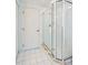 Bathroom with a walk-in shower and white tile at 4525 S Atlantic Ave # 1502, Port Orange, FL 32127