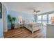 Main bedroom with ocean views, light wood floors and ceiling fan at 4525 S Atlantic Ave # 1502, Port Orange, FL 32127