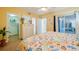Bedroom with a queen-size bed and access to a balcony at 4525 S Atlantic Ave # 1502, Port Orange, FL 32127