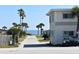 Oceanfront property with palm trees and walkway to the beach at 1510 Ocean Shore Blvd # 4140, Ormond Beach, FL 32176