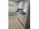 Efficient kitchen with white cabinets, tiled floors, and modern appliances at 1510 Ocean Shore Blvd # 4140, Ormond Beach, FL 32176