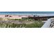 Beach access with boardwalk and people enjoying the sand at 1510 Ocean Shore Blvd # 4140, Ormond Beach, FL 32176