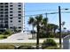 View of the ocean from parking lot, palm trees and building visible at 1510 Ocean Shore Blvd # 4140, Ormond Beach, FL 32176